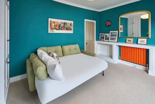 a living room with a couch and a mirror at Host & Stay - Window on the World in Brighton & Hove