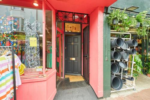a pink building with a door and a store at Host & Stay - Window on the World in Brighton & Hove