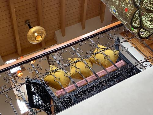 a group of yellow birds sitting on a balcony at Riad eSSAOUIRA View in Essaouira