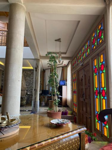 a room with columns and stained glass windows at Riad eSSAOUIRA View in Essaouira