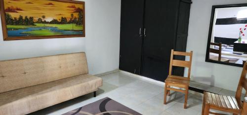 a living room with a couch and a chair at HOTEL CAMPESTRE CRISTALES cerca al mar By AMAUNA in San Bernardo del Viento