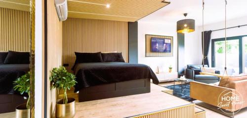 a bedroom with a bed and a living room at Home Sweet House in Hermée