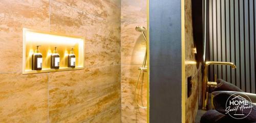 a bathroom with a shower with wine bottles on the wall at Home Sweet House in Hermée