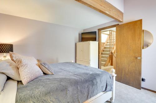 a bedroom with a bed and a wooden door at Charming Townhome - Walk to Greek Peak Mountain! in Cortland