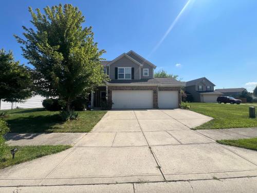 a house with a driveway and a garage at Grand Park Spa Getaway in Westfield