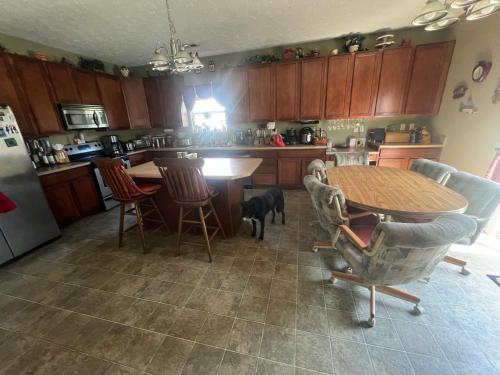 a kitchen with a table and chairs and a dog in the kitchen at Grand Park Spa Getaway in Westfield
