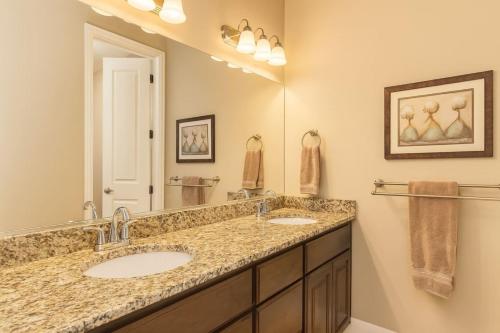 a bathroom with two sinks and a large mirror at Ridge House - Two Pools Near Zion in Washington
