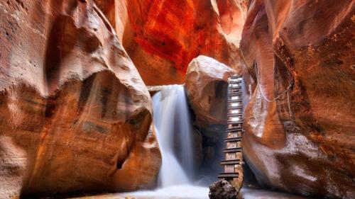 a ladder in the middle of a slot canyon at Ridge House - Two Pools Near Zion in Washington