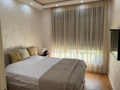 a bedroom with a large bed and a window at Harmony Apartment 2 in Bar