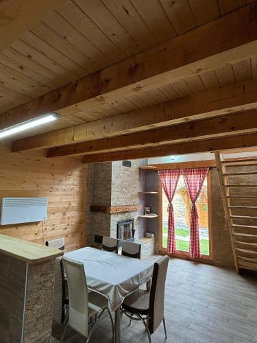 a room with a table and chairs and a fireplace at Vikendice Jovicic in Bukorovac