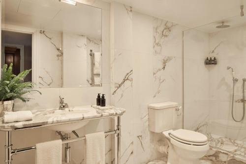 a bathroom with a toilet and a sink and a shower at Milestone Hotel Kensington in London