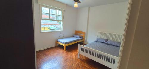 Ένα ή περισσότερα κρεβάτια σε δωμάτιο στο PIT04- Apartamento 4Min a pé da Praia da Pitangueias