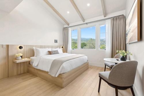 a bedroom with a bed and a desk and a window at Casa Riviera - Boutique Suites in Downtown Santa Barbara in Santa Barbara