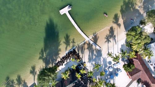 an overhead view of a beach with palm trees and the water at River Lodge Resort in Ntchogo