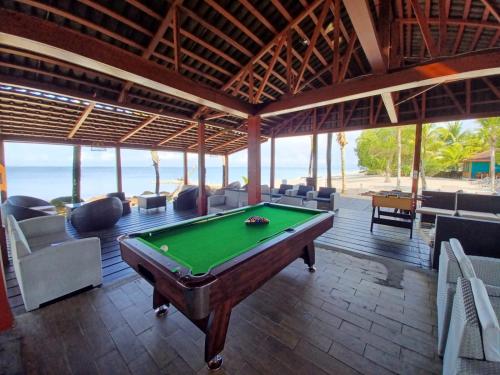 a pool table in a room with a view of the ocean at River Lodge Resort in Ntchogo