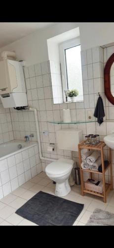 a bathroom with a toilet and a sink and a mirror at Wohnung Ideal für Ihr Projekt in Mülheim an der Ruhr