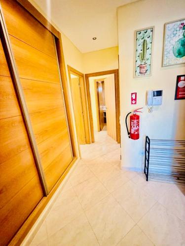 a hallway with a wooden door and a fire hydrant at Luxury 2 bed Carvoeiro in Carvoeiro