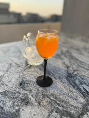 a glass of orange juice sitting on a table at Luxury house in SODIC Villette with jacuzzi in Cairo