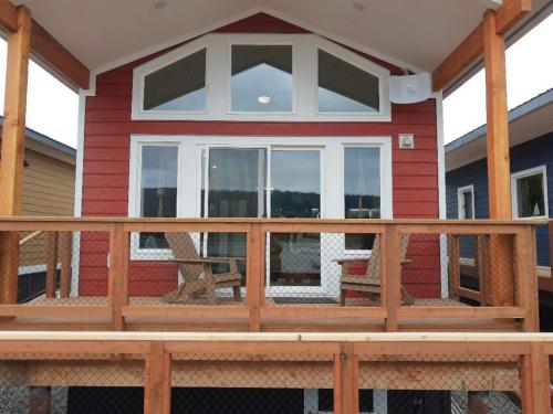 a front porch of a house with a large window at Dockside Cabin - Homer Seaplane Base in Homer