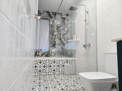 a white bathroom with a shower and a toilet at Summer House with Private Pool in K'obulet'i