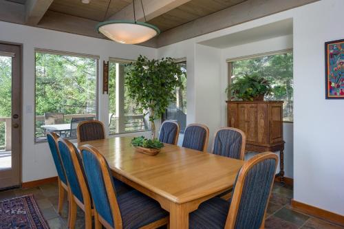 a dining room with a wooden table and chairs at Elegant Water View, Walk To Moran State Park in Eastsound
