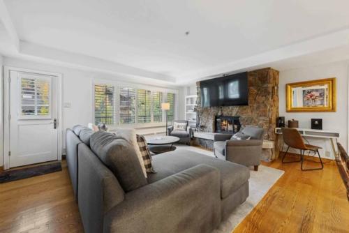a living room with a couch and a fireplace at Lodge Tower 487 Two Bedroom Residence in Vail
