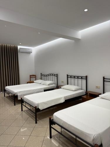 a row of beds in a room at Vironas Hotel in Himare