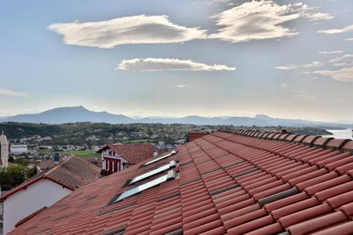 a red roof with a view of a city at Hôtel & Appart-hôtel Olatua in Bidart