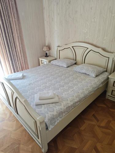 a bedroom with a bed with two towels on it at Liberty Square Accommodation I in Tbilisi City