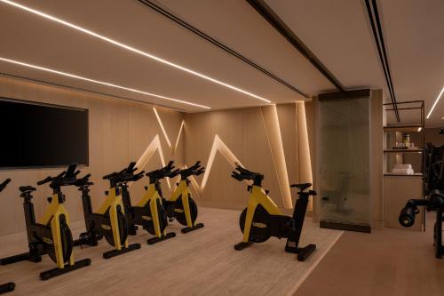 a group of exercise bikes in a room with a flat screen tv at Giza Palace Hotel & Spa - The Leading Hotels Of The World in 6th Of October