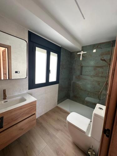 a bathroom with a toilet and a sink and a shower at Mamba Garden III in Calpe