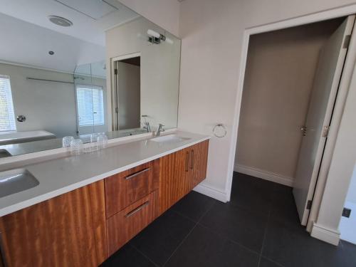 a bathroom with a sink and a large mirror at Wild Mushroom Country House in Stellenbosch