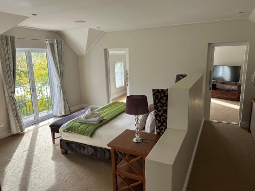 a bedroom with a bed and a table with a lamp at Wild Mushroom Country House in Stellenbosch