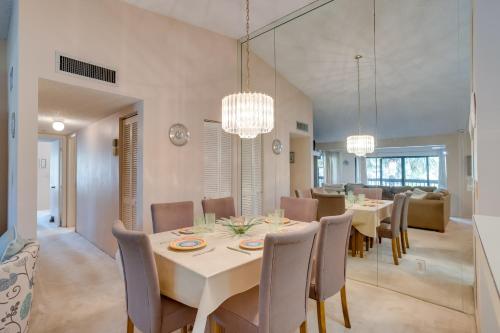 a dining room with a table and chairs at Pool and Ocean Access Palm Beach Gardens Condo in Palm Beach Gardens