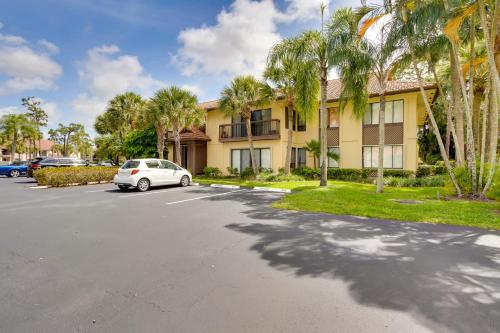 a car parked in front of a building with palm trees at Pool and Ocean Access Palm Beach Gardens Condo in Palm Beach Gardens