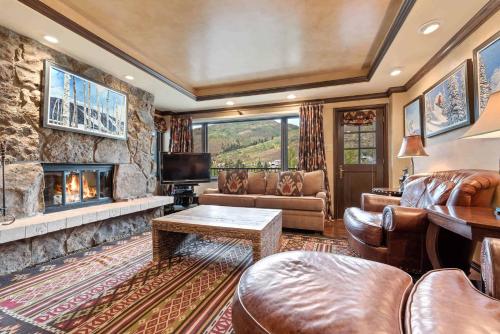a living room with a couch and a fireplace at Lodge Tower 494 One Bedroom Residence in Vail