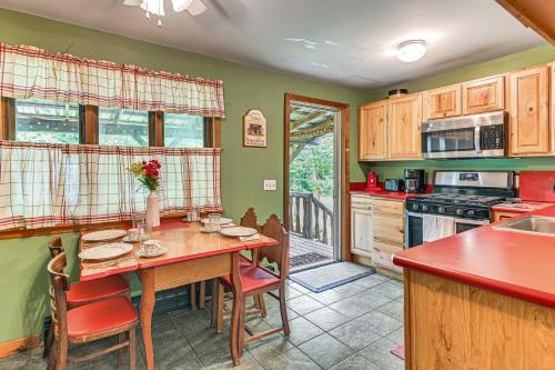 a kitchen with a wooden table with chairs and a tableasteryasteryasteryasteryastery at Less Than 8 Mi to Gore Mountain! Family Cottage with Porch in Bakers Mills