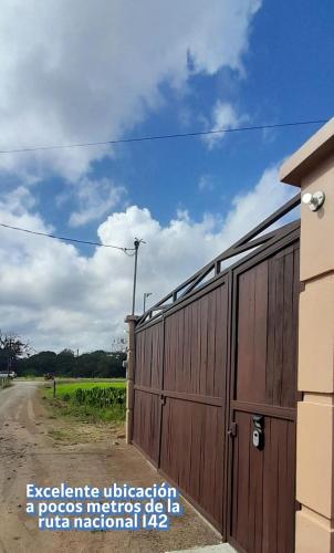 a wooden fence next to a dirt road at The loft arenal in Fortuna