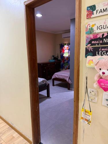 a teddy bear is hanging on a wall in a room at Casa em Benfica oito Pessoas no mínimo in Benevides