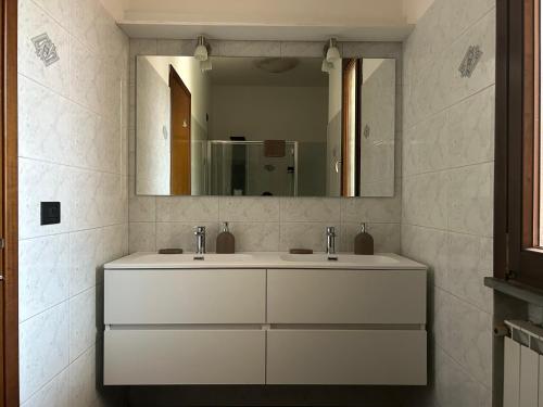 a bathroom with two sinks and a large mirror at Dimora Toscana in Treggiaia