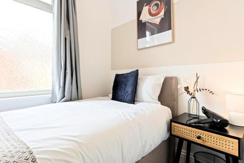 a bedroom with a bed and a window at Charlotte Street House in Redcar
