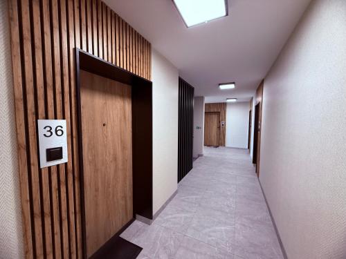 a hallway with a door with a sign on it at LOFT APARTAMENT II Kępno in Kępno