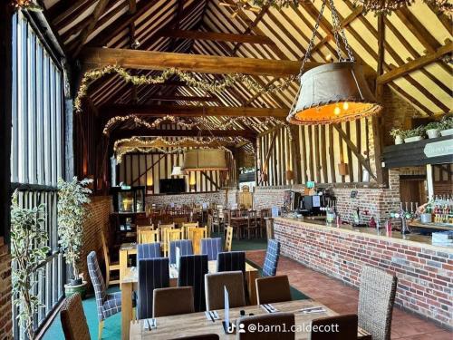 a restaurant with tables and chairs in a building at Whispering Pines in Great Yarmouth