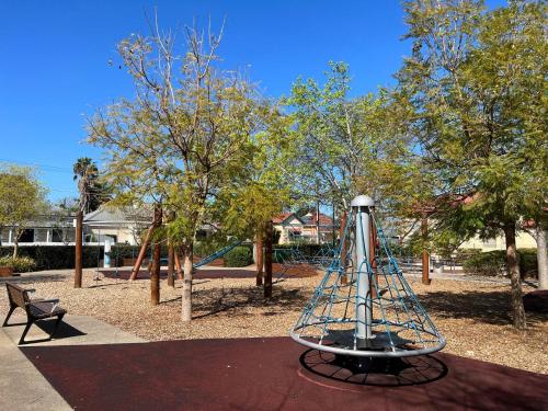 a park with a playground with a swing at No Stairs, Big House, Garage Richmond Residence 1 in West Richmond