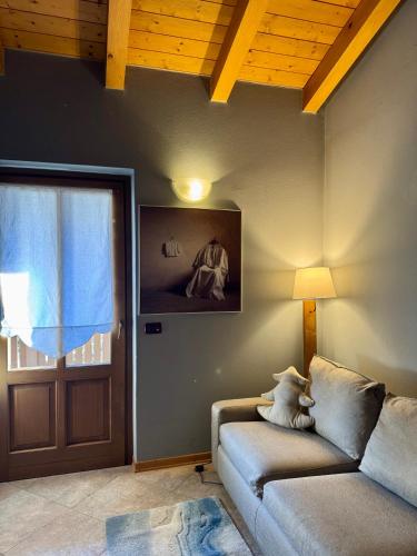 a living room with a couch and a door at Marangon Apartments in Sùtrio
