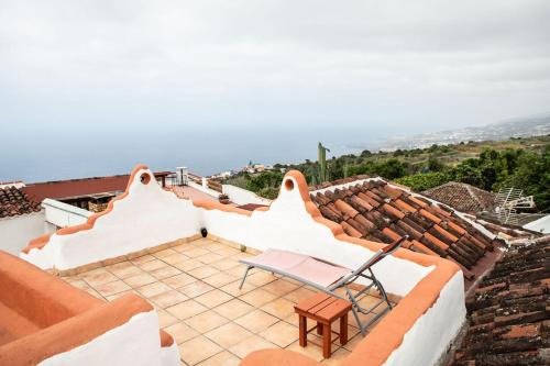 a chair on the roof of a house at Casa in The Clouds in Genovés