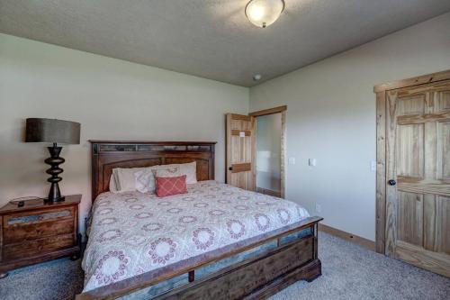 a bedroom with a bed and a lamp on a table at Holy Terror Chalet At Terry Peak Ski Resort in Lead