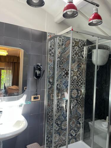 a bathroom with a shower and a sink at Hotel Villa dei Pini in San Terenziano