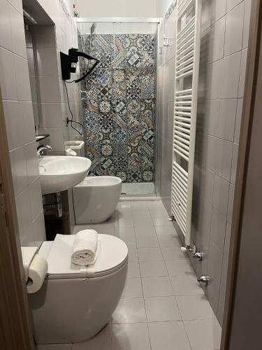 a bathroom with a toilet and a sink and a shower at Hotel Villa dei Pini in San Terenziano