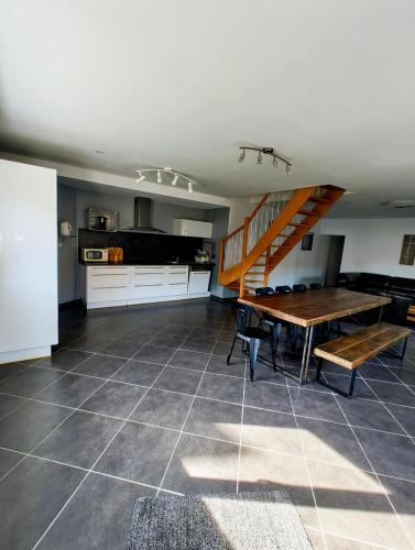 a kitchen and dining room with a table and a staircase at Olhain - La Parenthèse in Fresnicourt-le-Dolmen